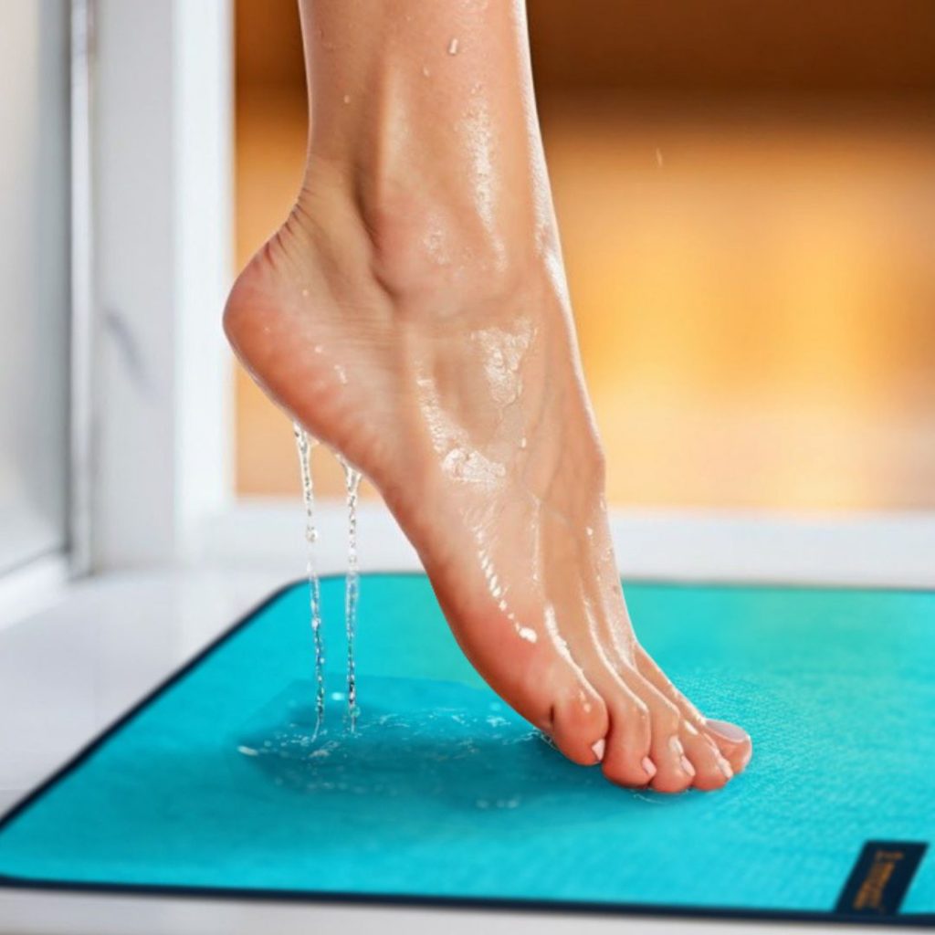 ladies dripping foot stepping out of shower onto anti slip mat
